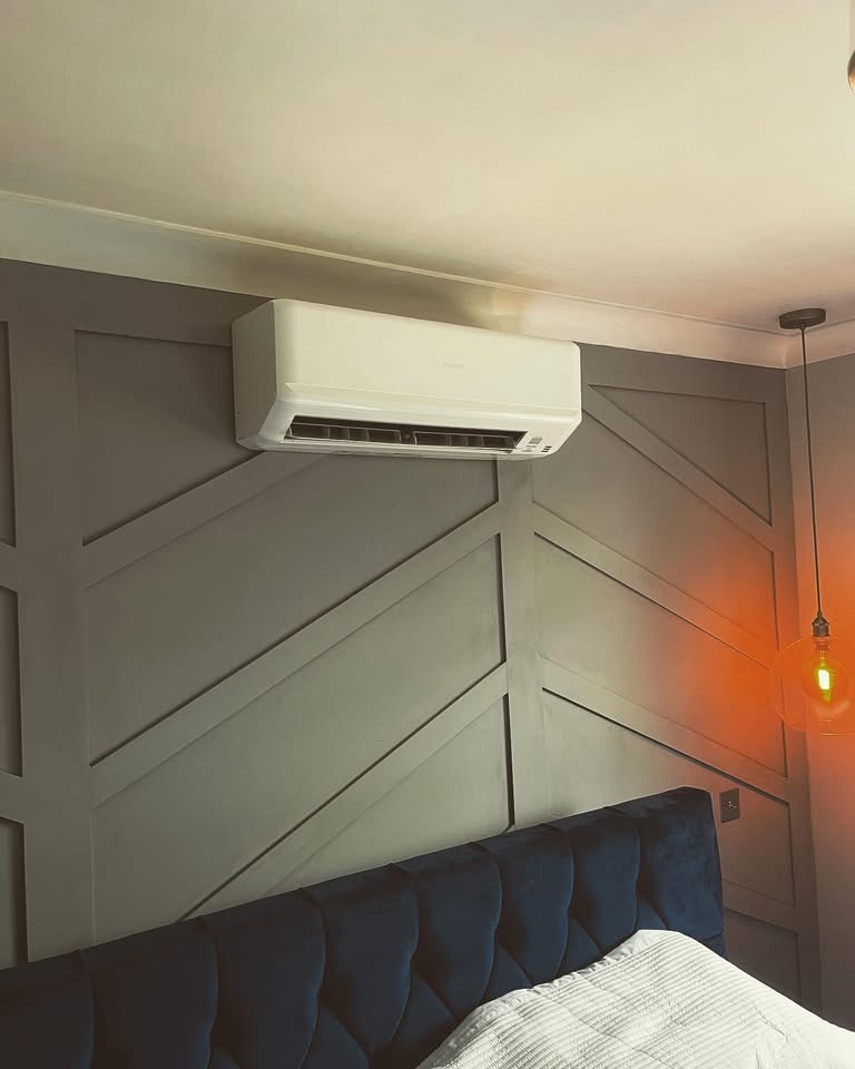 Mitsubishi wall-mounted split air conditioning unit installed in a bedroom by Hall HVAC