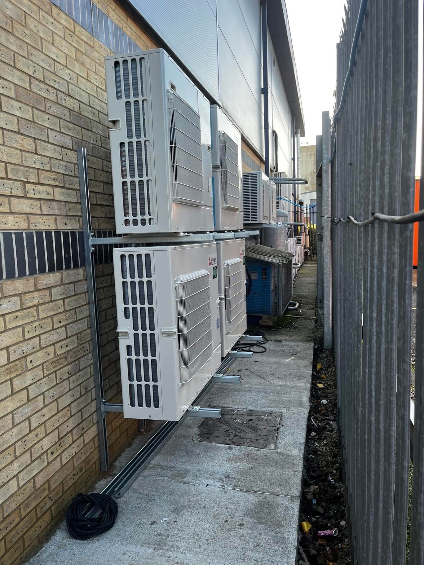 Bank of Mitsubishi Electric outdoor condenser units serviced by Hall HVAC on a commercial site